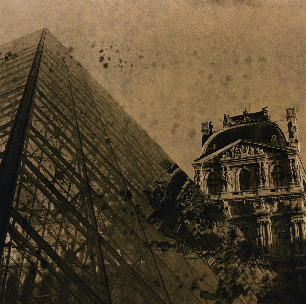 Lith print of the Louvre pyramid and palace with dark peppercorn speckling across the sky