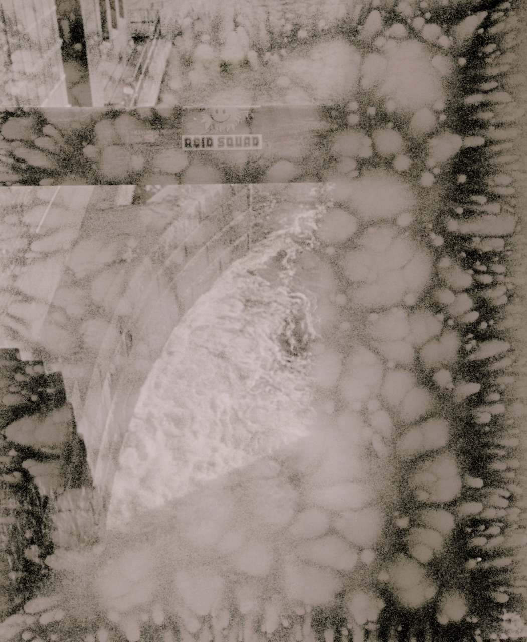 Lith print of a Tampere weir covered in pale circular snowball defects