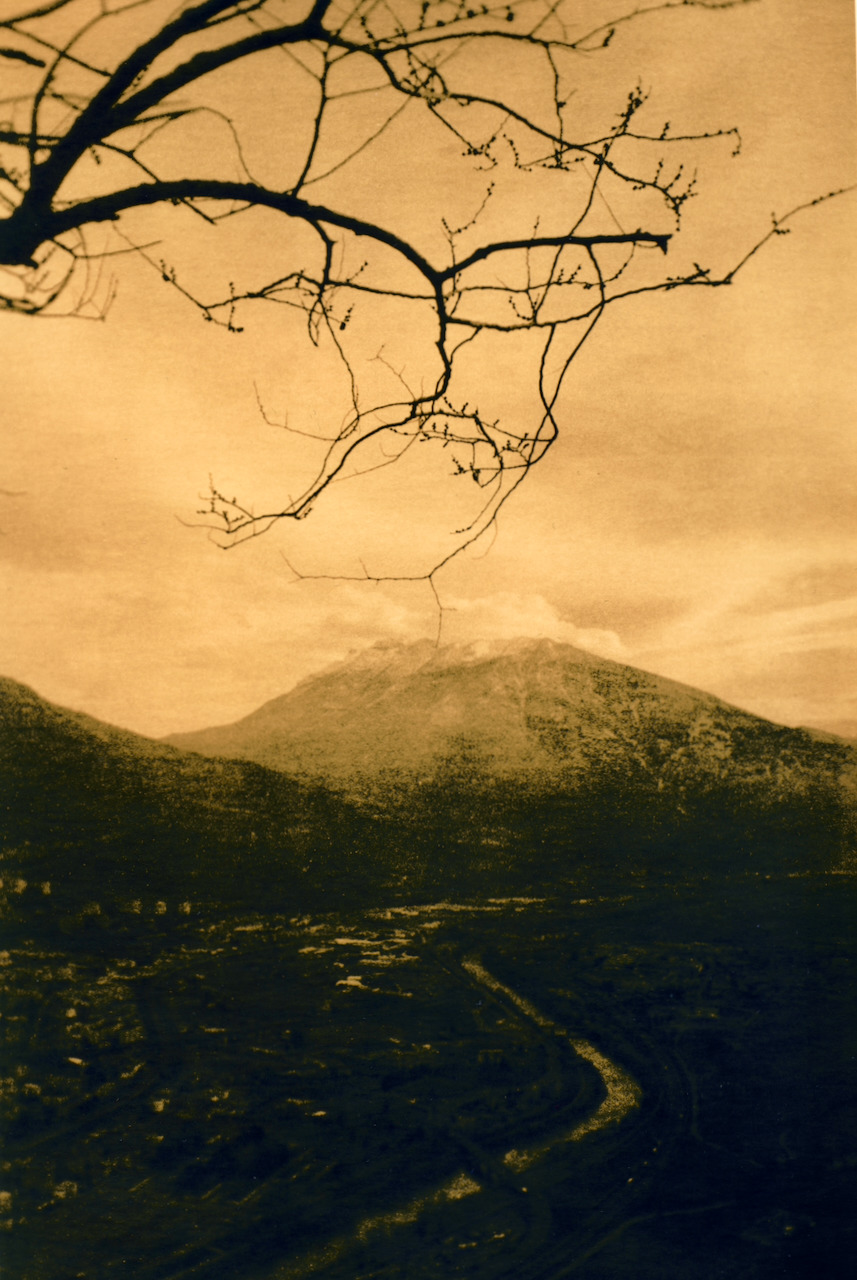 Lith print of a mountain valley, high contrast, with the foreground blocked into deep shadow