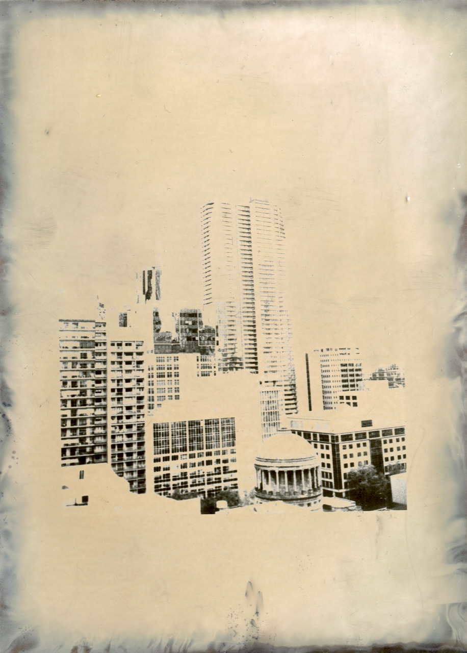 A city skyline printed on Fomaspeed, the image floating in a pale cream field with dark mottled deposit along the paper edges