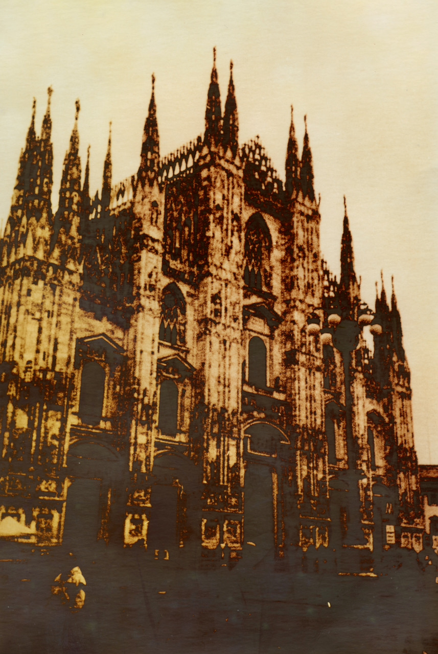 Milan cathedral in warm gold and brown lith tones, with mirrored shadows