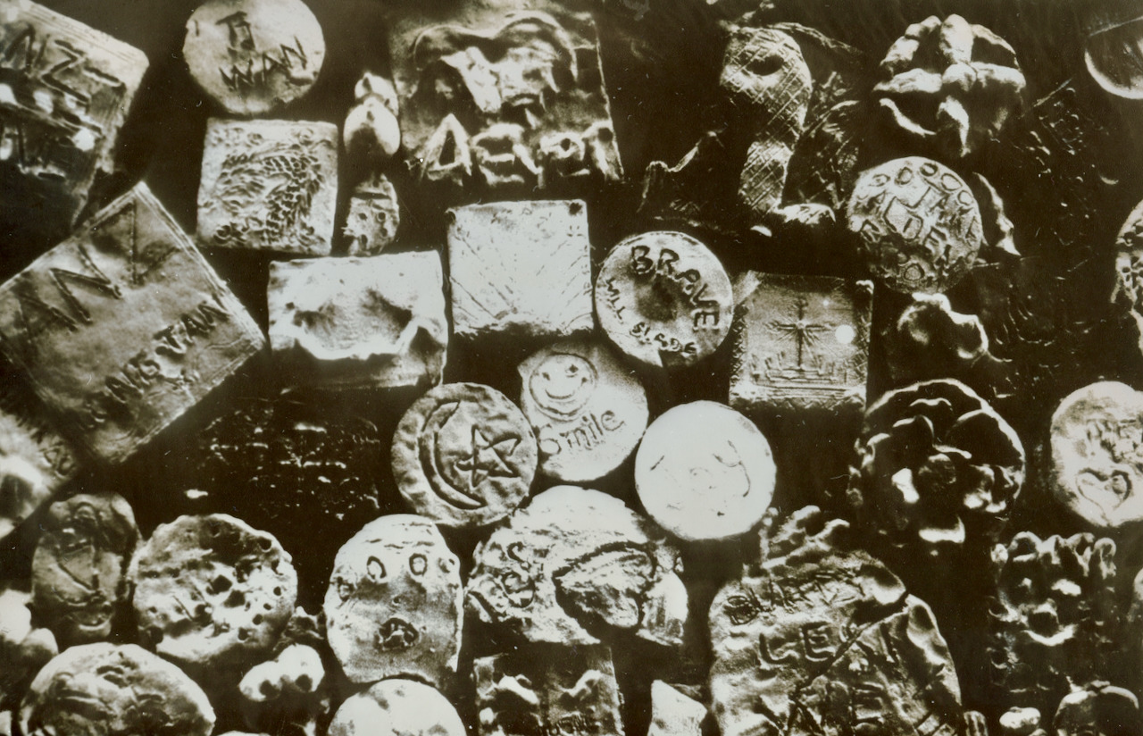 Wall of stamped clay tokens, conventional black and white silver mirror toned print